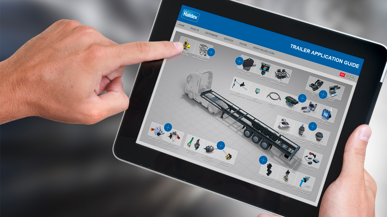 Hand navigates on a tablet showing Haldex Trailer application guide